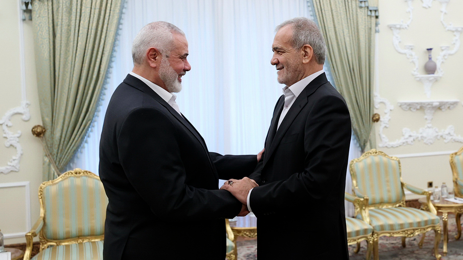 Iranian President Masoud Pezeshkian greets Hamas leader Ismail Haniyeh